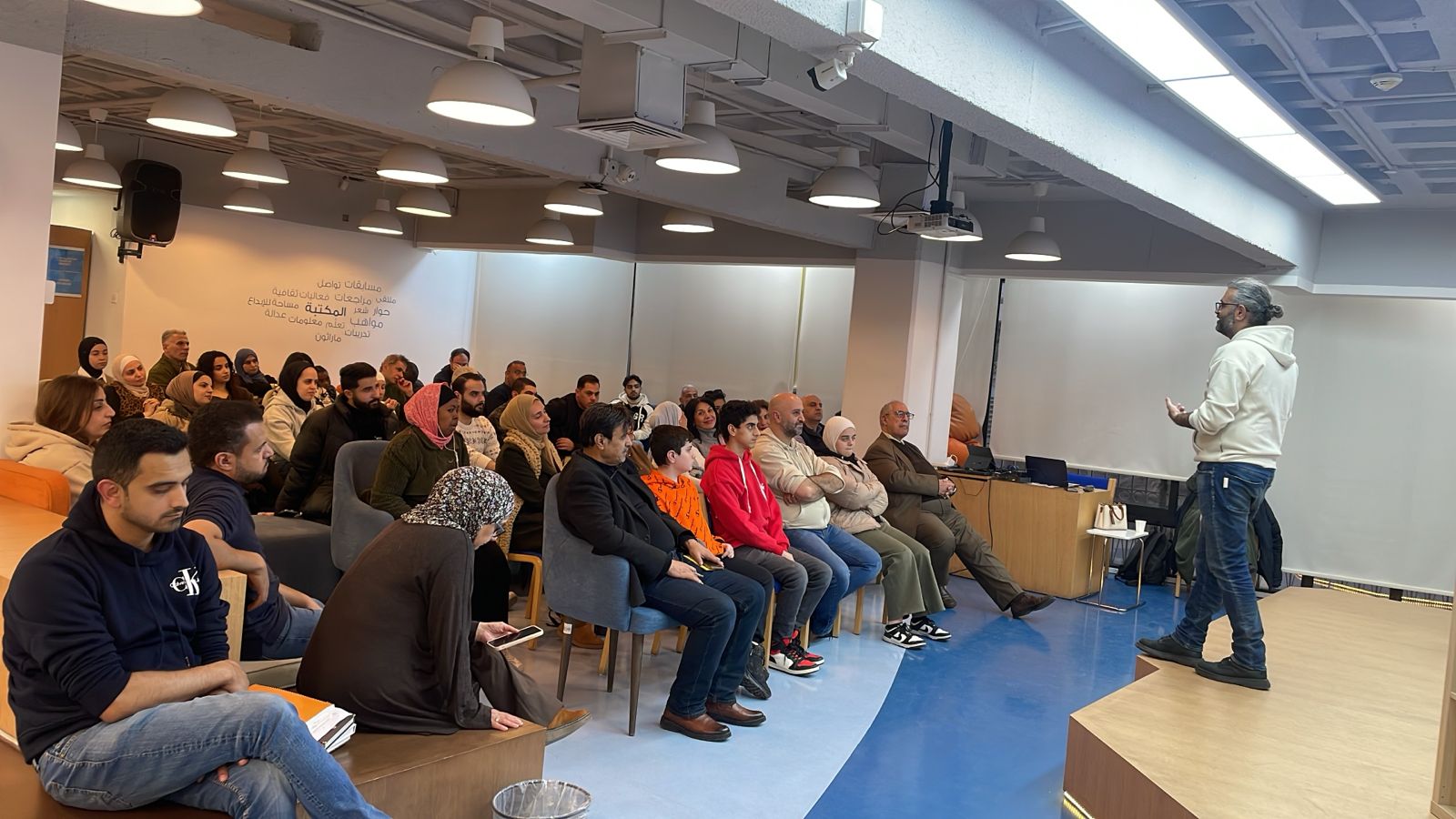 Abdul Hameed Shoman Foundation session — wide view of the room, audience seated, Mousa Soutari presenting on the right, Amman, February 2026.