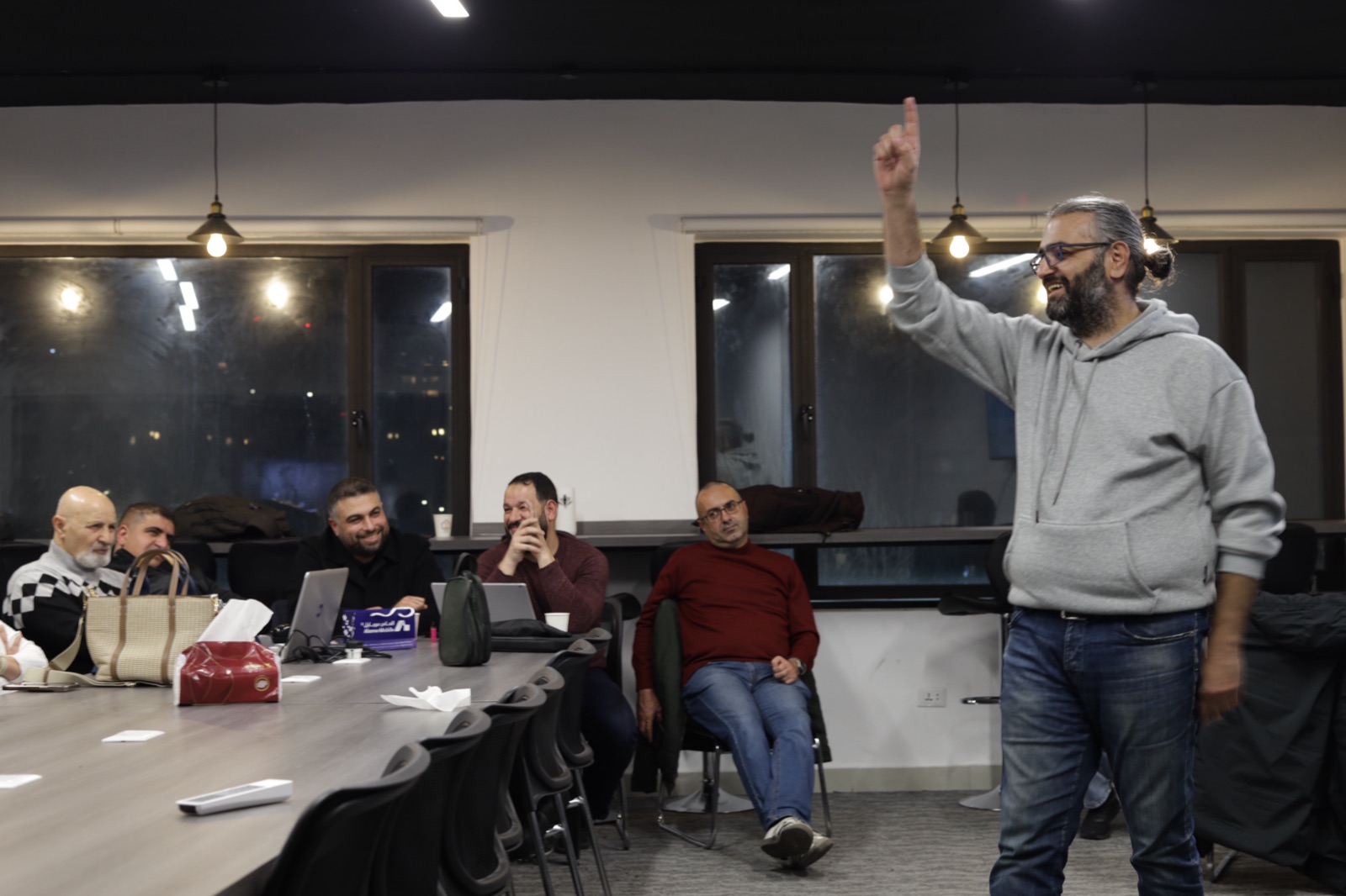 Sigma Study House evening session — Mousa Soutari presenting to an engaged audience under warm Edison-bulb lighting, Amman, March 2026.